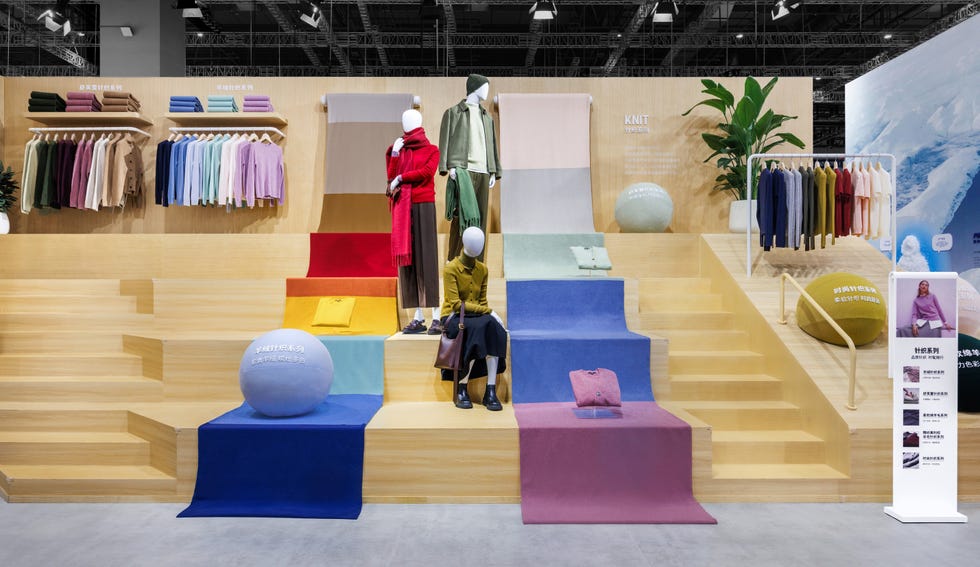 a clothing display featuring colorful garments on shelves and mannequins